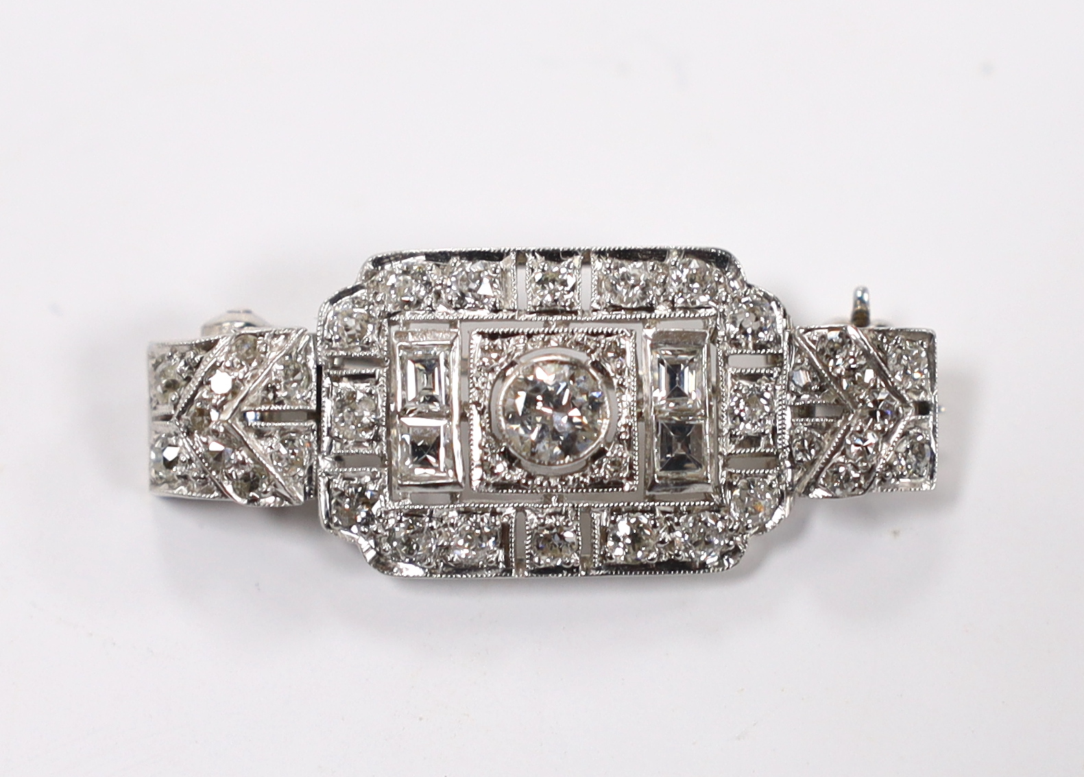 An Art Deco style white metal and millegrain set round and square cut diamond cluster pendant brooch, 33mm, gross weight 6.1 grams.